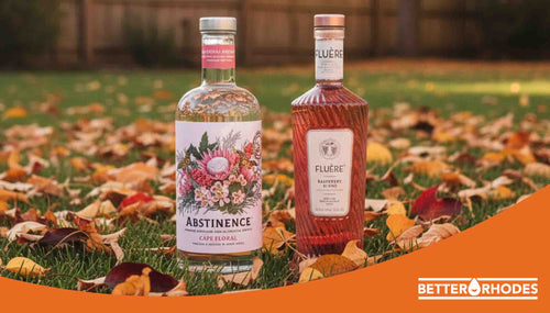 Two non-alcoholic spirits bottles on autumn leaves outdoors