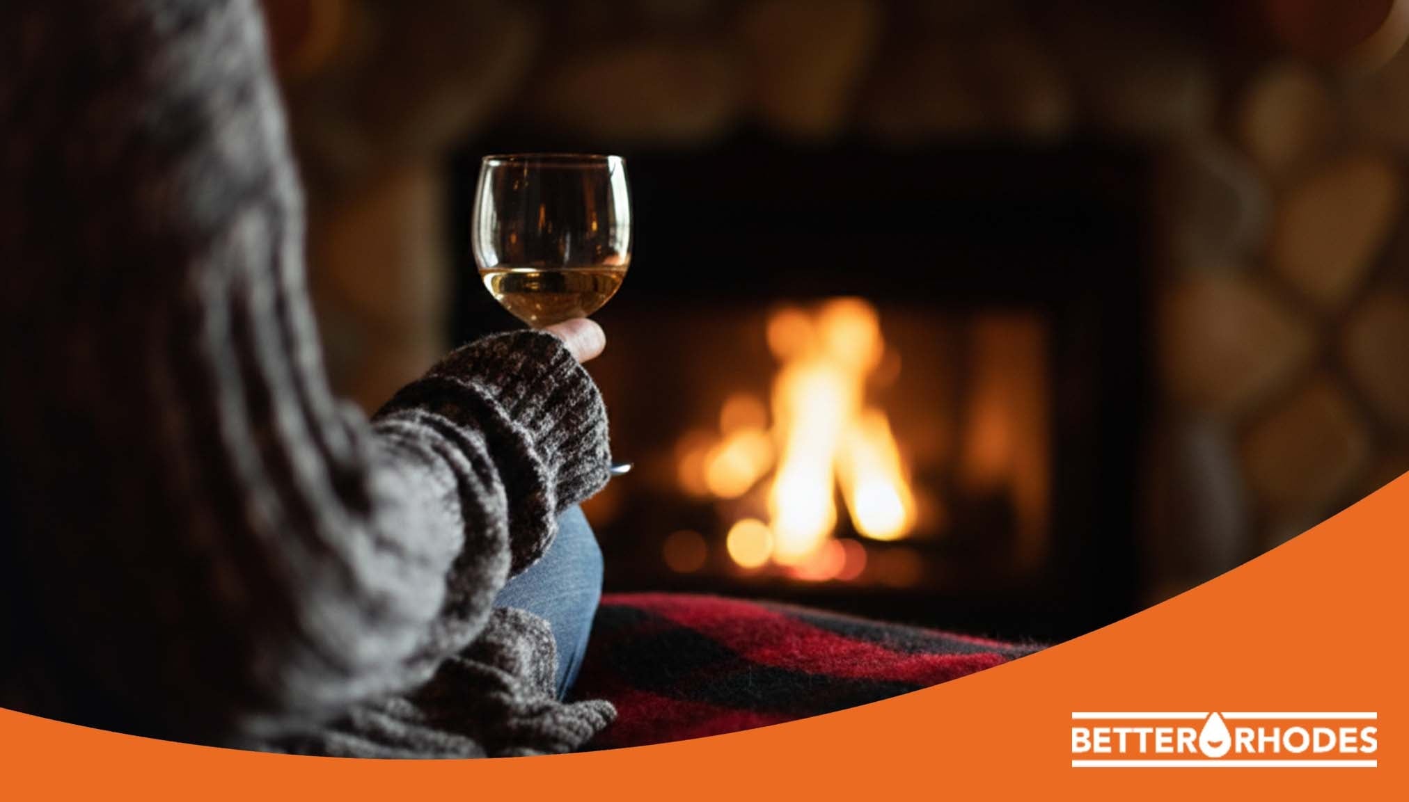 Enjoying a glass of non-alcoholic wine by a cozy fireplace