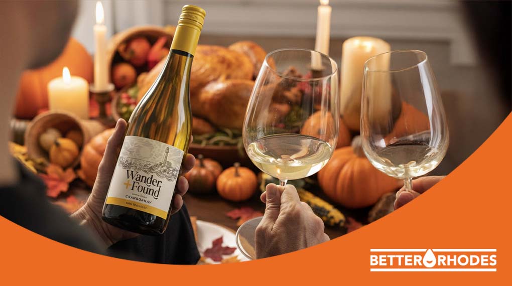 wo people clinking glasses of non-alcoholic white wine at a Thanksgiving dinner table