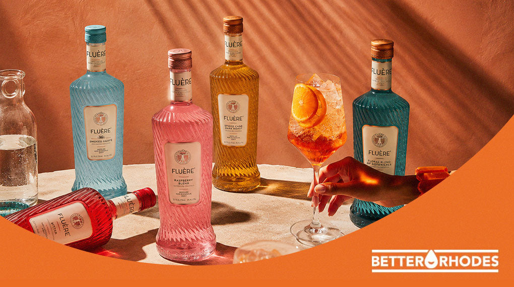 Fluère non-alcoholic spirits collection with a garnished spritz cocktail