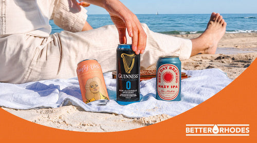 Non-alcoholic beers on a beach towel — Better Rhodes summer BBQ picks
