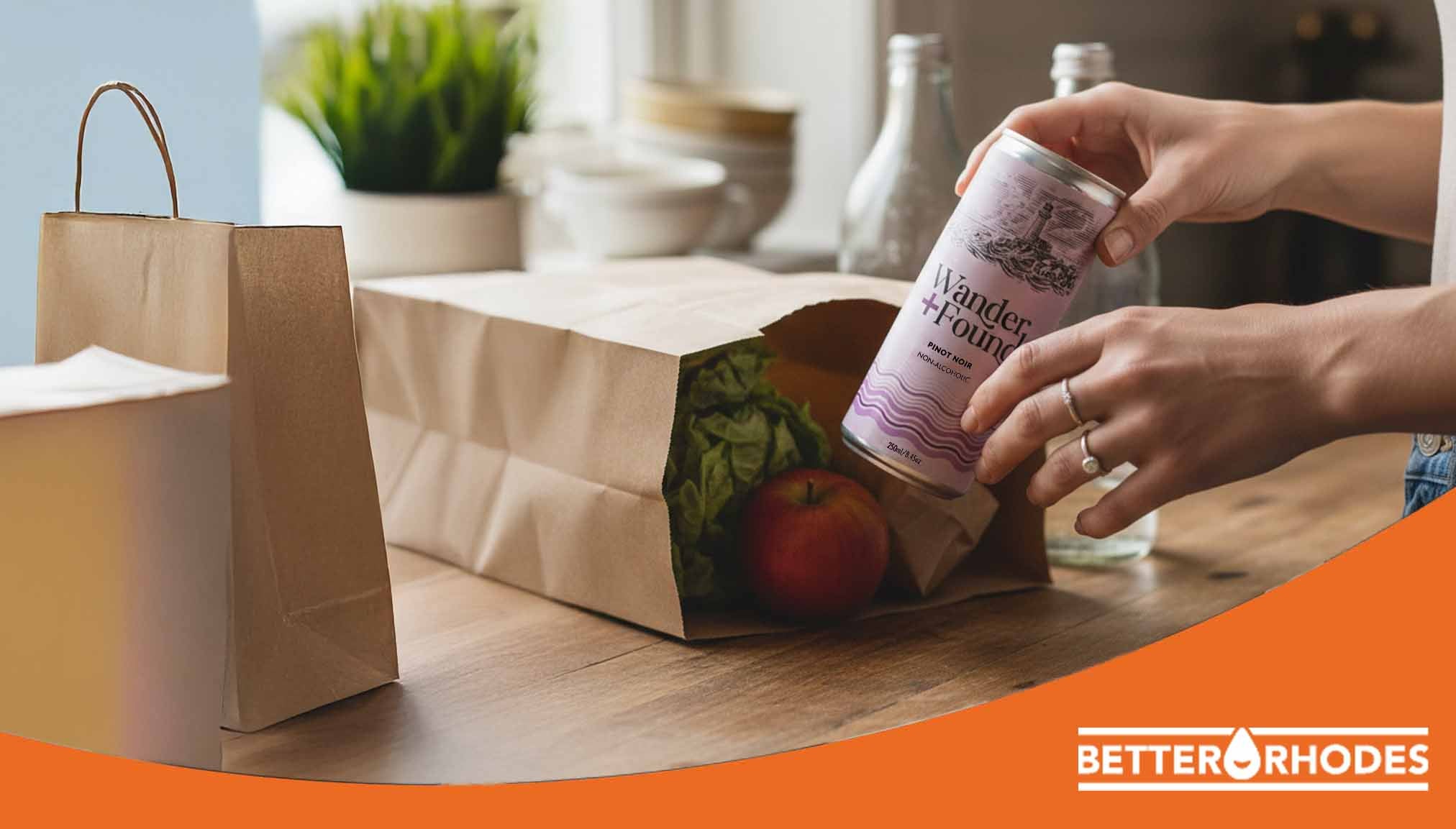 Non-alcoholic cooking wine being added to a kitchen pantry alongside fresh groceries